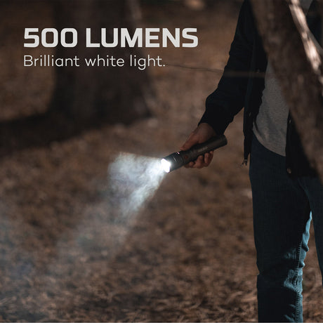 Handheld flashlight emitting a bright 500-lumen beam of white light.