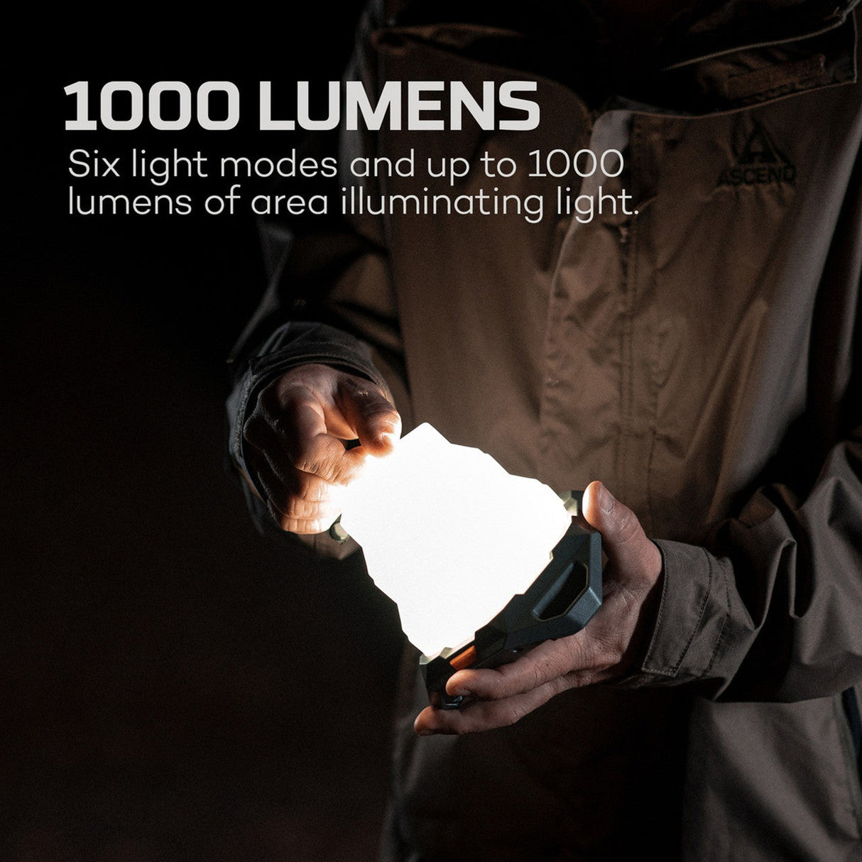 Glowing portable light source held in hands, emitting 1000 lumens with six modes.