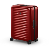Red hardshell rolling suitcase with horizontal ridges and a logo.