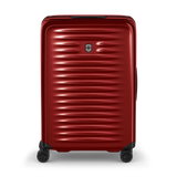 Red hardshell rolling suitcase with horizontal ridges and a Swiss Army logo.