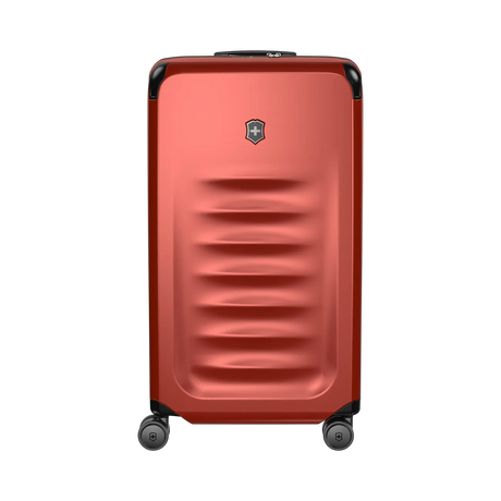 Red hardshell rolling suitcase with horizontal ridges and a logo emblem.