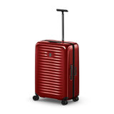 Red hardshell rolling suitcase with horizontal ridges and an extendable handle.