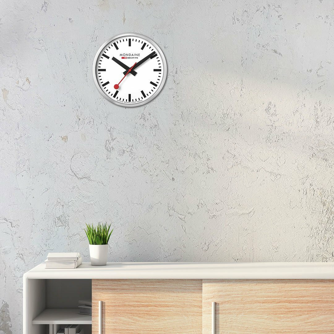 Classic round wall clock with black hands and red second hand.
