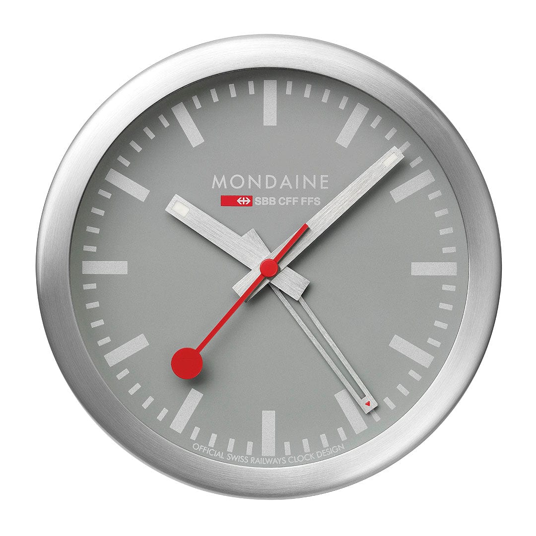 Minimalist analog wall clock with a silver frame and red hands.