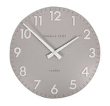 Gray wall clock with white numbers and hands, branded ’Thomas Kent London’.